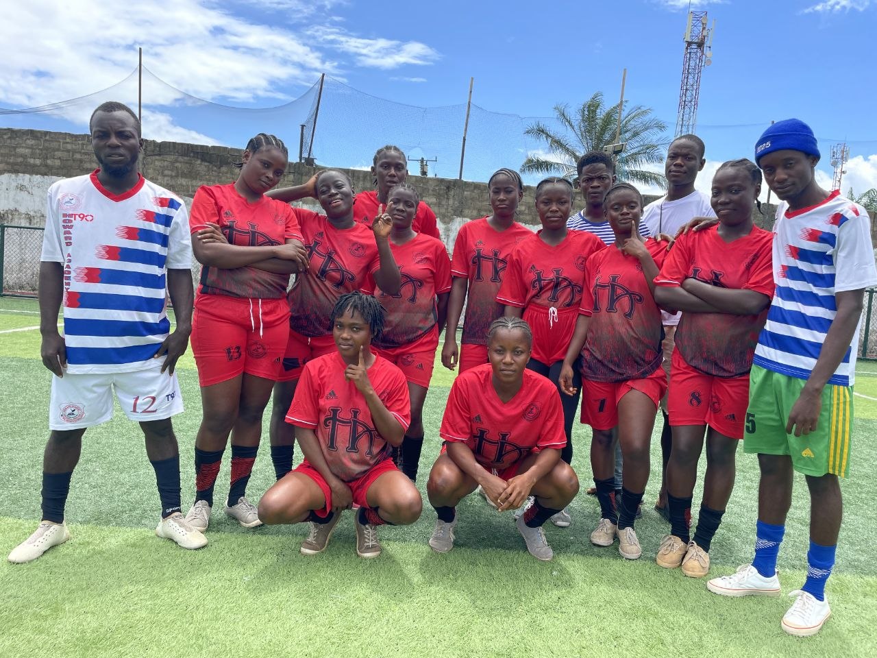 Howard Academy Mighty Eagles athletes in red uniform celebrating a national title